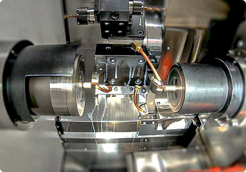Close-up of CNC machine processing a hardened shaft with precision